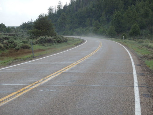 The road is warm and rain is evaporating.